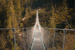 Woman crossing bridge to represent consumer closing the confidence gap